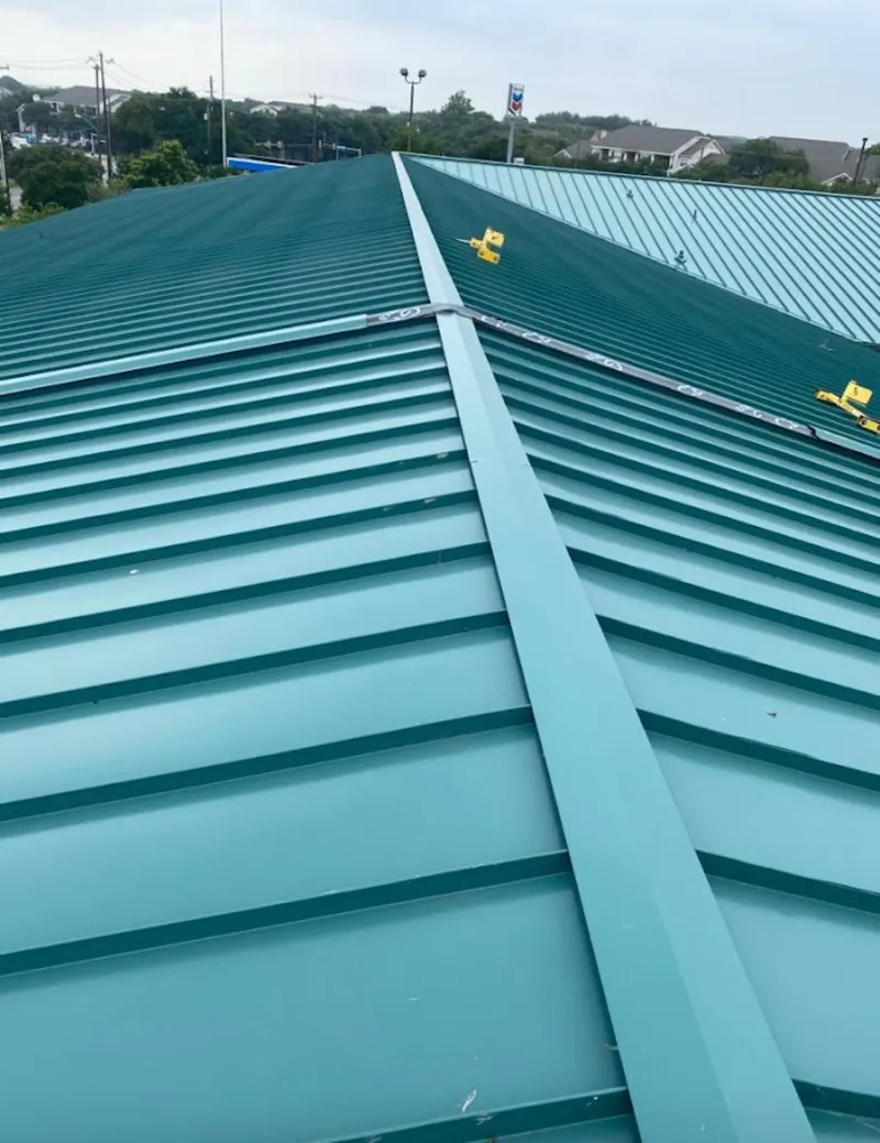 Green commercial metal roof ridge and valley for Metal Roof Repair in North Liberty