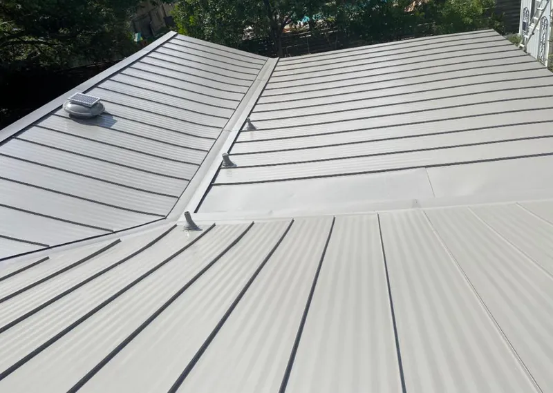 Solar attic fan installed on a metal roof for Roof Ventilation in North Liberty